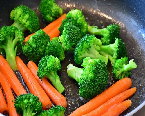 Hands preparing a healthy meal with fresh vegetables